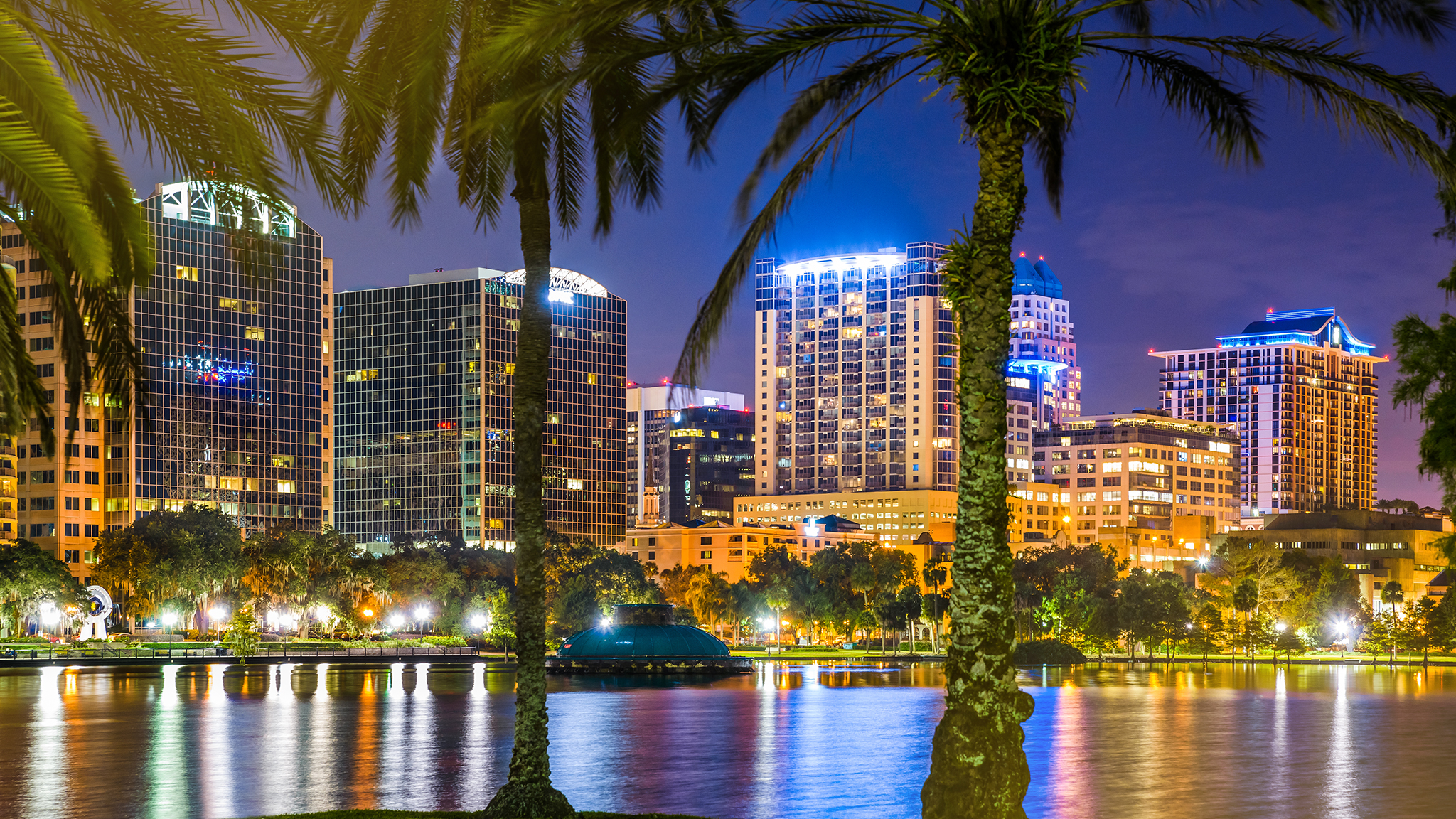 Downtown Orlando city lights shine at night.