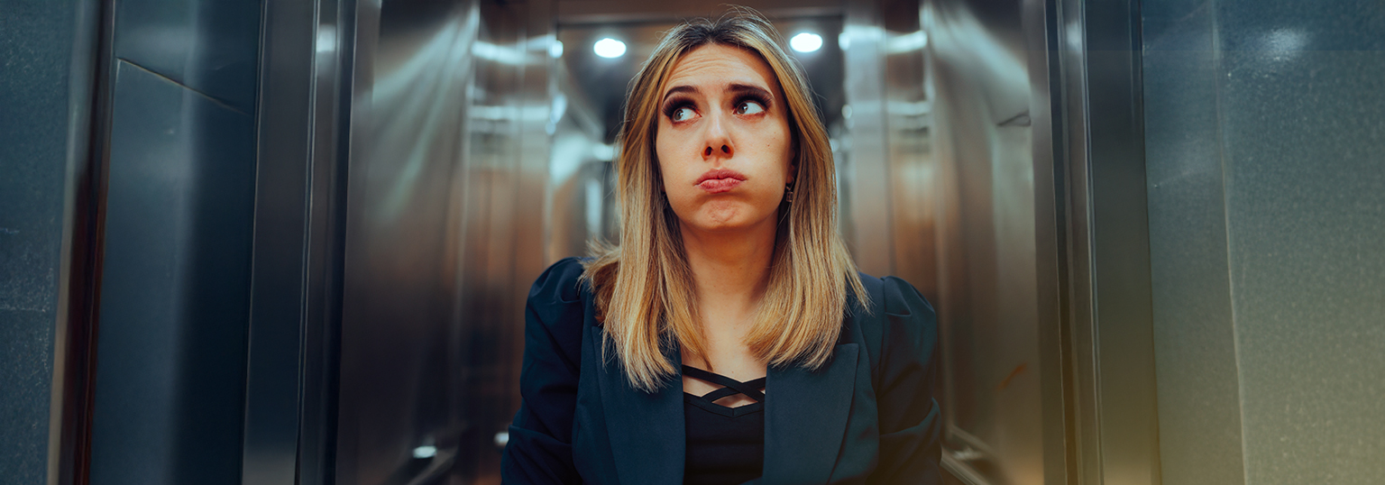 Stressed Office Goer in the Interior of an Elevator